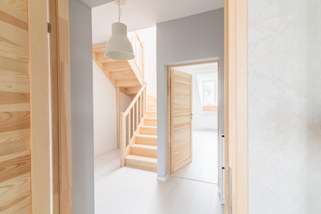 Pine stairs in hall. Modern, bright attic apartment.の写真素材
