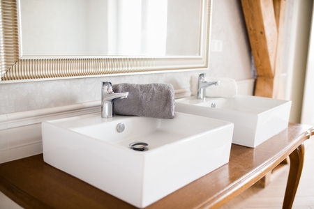 Double white wash basins in vintage styled loft bathroomの写真素材
