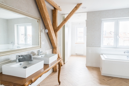 Wash basins in loft bathroom. Modern, bright attic apartment.の写真素材