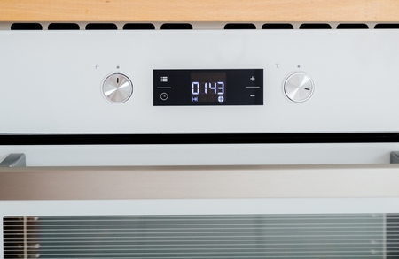 Temperature regulation control panel and knobs in modern electric kitchen cookerの写真素材