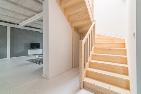 Pine stairs in hall. Modern, bright attic apartment.の写真素材
