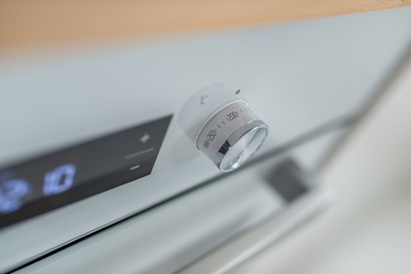 Temperature regulation knob in modern electric stoveの写真素材
