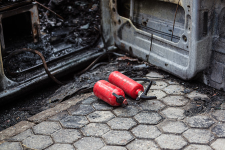 Used car fire extinguisher. Burnt car on road. Car accidentの写真素材