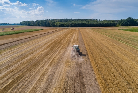 Tractor plowing field after harvesting. Farm worksの写真素材