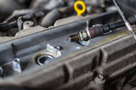 Old broken car spark plugs. Car repair. Replacement of spark plugs