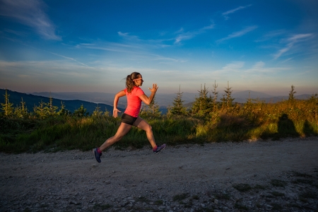 Woman running in mountains. Woman trail runner. Szczyrk, Beskidy Mountains, Polandの写真素材