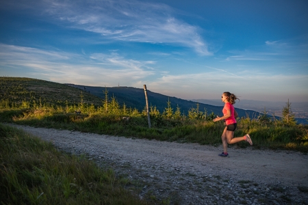Woman running in mountains. Woman trail runner. Szczyrk, Beskidy Mountains, Polandの写真素材