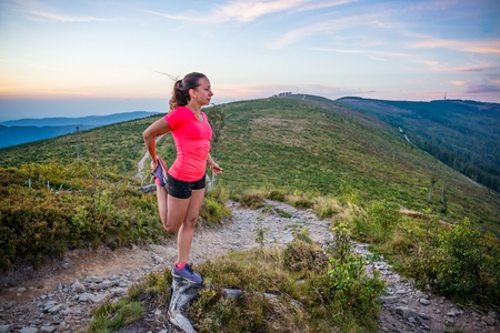 Woman stretching after trail running in mountains. Szczyrk, Beskidy Mountains, Silesian Beskid, Polandの写真素材