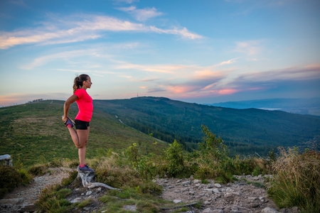 Woman stretching after trail running in mountains. Szczyrk, Beskidy Mountains, Silesian Beskid, Polandの写真素材
