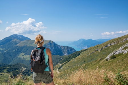 Woman on mountain trail. Female in Italian Alps, Monte Baldo mountainの写真素材