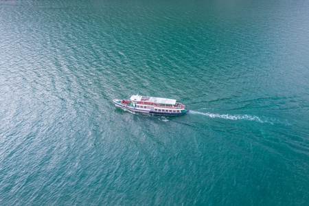 Aerial drone view on touristic boat on calm water of Lake Garda in Italyのeditorial素材