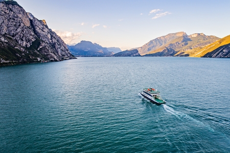 Aerial drone view on car ferry on calm waters of Lake Garda in Italy, Limone sul Gardaのeditorial素材