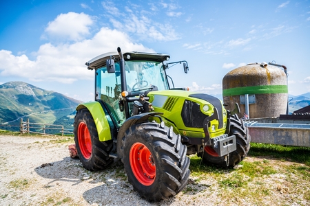 Green tractor on farm in Italian Alps mountainsのeditorial素材