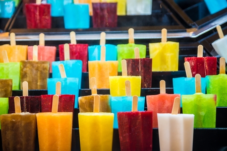 Freshly made fruit ice creams. Delicious fresh colourful ice lolly on stick.の写真素材