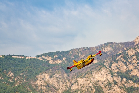 Firefighters water bomber aircraft in action in Italian mountainsのeditorial素材