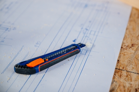 Paper knife on house construction project. Renovation, construction conceptの写真素材