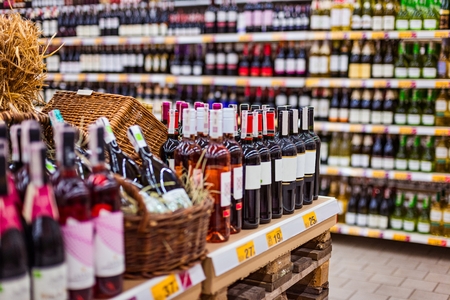 Bottles of wine and other alcohols in supermarkeの写真素材