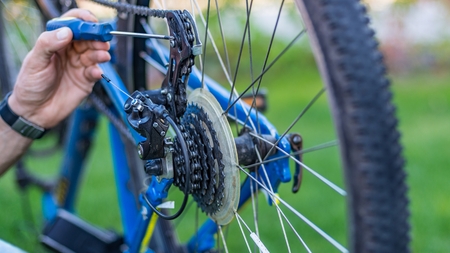 Service technician adjusting bike gears. Bike serviceの写真素材