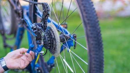 Service technician adjusting bike gears. Bike serviceの写真素材
