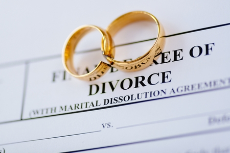 Broken golden wedding rings divorce decree document. Divorce and separation conceptの写真素材