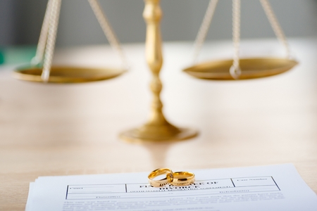 Broken golden wedding rings divorce decree document. Divorce and separation conceptの写真素材