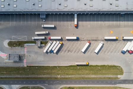 Aerial drone view on warehouse and logistic center. Logistic and transport concept