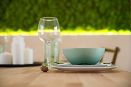 Modern tableware with ceramic bowl and plates on the wooden tableの写真素材