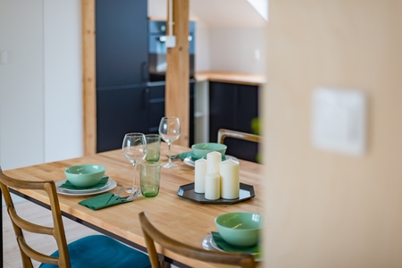 View from hall to set dining table in the open kitchenの写真素材