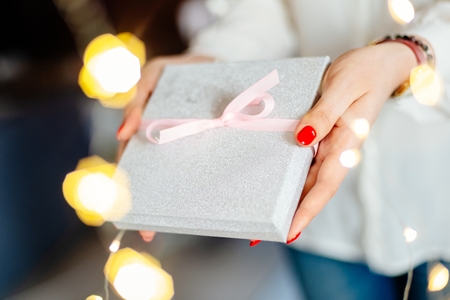 Female giving box with ribbon surprise gift. Christmas present giftの写真素材