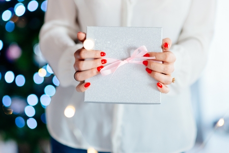 Woman holding present. Christmas surpriseの写真素材