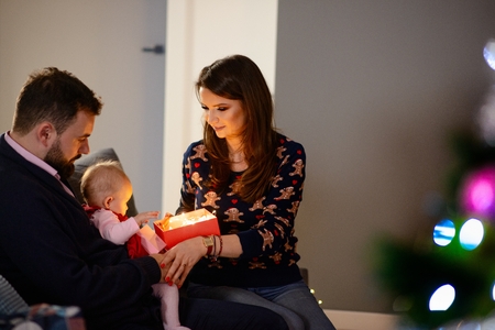 Happy family with newborn at Christmas. Christmas surprise. Merry Christmas!の写真素材