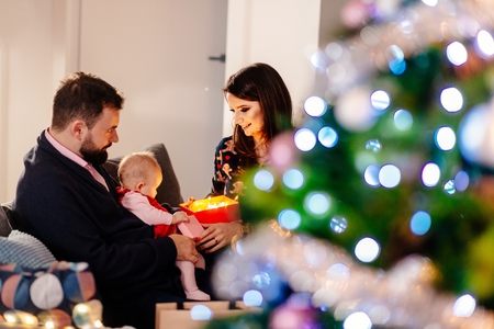 Family with newborn at Christmas. Christmas surprise. Merry Christmas!の写真素材