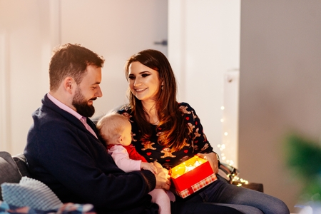 Happy family with newborn at Christmas. Christmas surprise. Merry Christmas!の写真素材