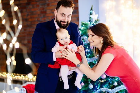 Woman giving Christmas present to her baby child. Family at Christmas. Christmas surprise. Merry Christmas!の写真素材
