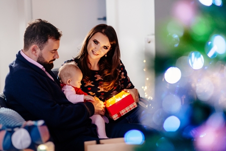 Happy family with newborn at Christmas. Christmas surprise. Merry Christmas!の写真素材