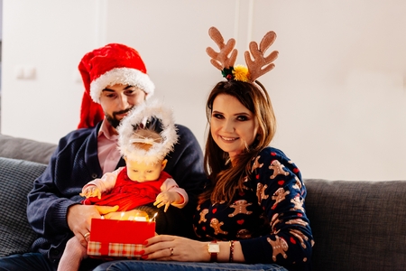 Baby first Christmas present. Family at Christmas. Christmas surprise. Merry Christmas!の写真素材