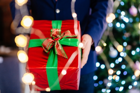 Male giving Christmas present. Christmas surprise. Merry Christmas!の写真素材