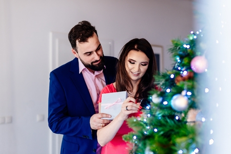Happy couple decorating Christmas tree. Merry Christmas!の写真素材