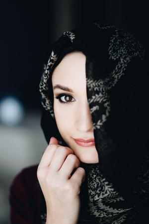 Mysterious beautiful middle eastern ethnicity woman wearing a hijabの写真素材