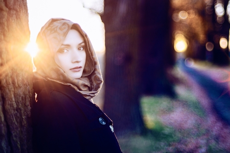 Young sad arabic woman in hijab outdoorsの写真素材