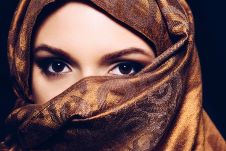 Young Arabian Muslim woman in hijab, studio shot. Black backgroundの写真素材