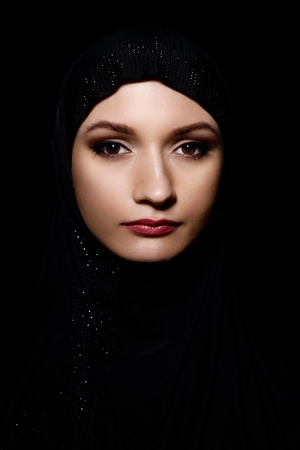 Young Arabian Muslim woman in hijab, studio shot. Black backgroundの写真素材