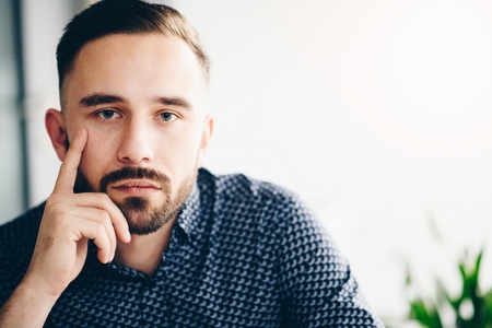 Caucasian thoughtful businessman in his office. Man working in office