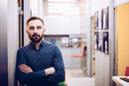Caucasian businessman with crossed hands in his office. Man working in office