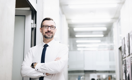 Middle aged handsome businessman in white shirt at office. Man working in officeの写真素材