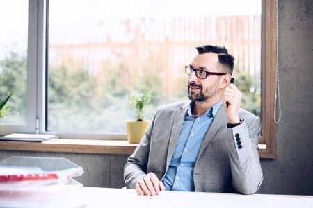 40 years old handsome businessman in office. Man working in officeの写真素材