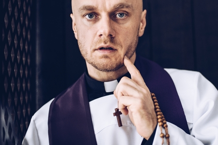 Priest confessives in the confessional. Faith and religionの写真素材