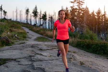 Woman cross country running in mountains at summer. Woman running. Silesian Beskid, Szczyrkの写真素材