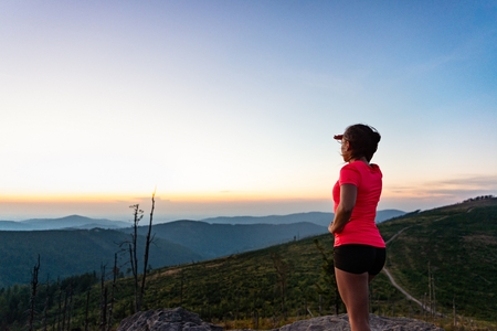 Woman cross country runner on mountain top at summer. Woman running. Silesian Beskid, Szczyrkの写真素材
