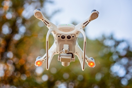 Unmanned aerial vehicle. White drone quadrocopter in flightの写真素材